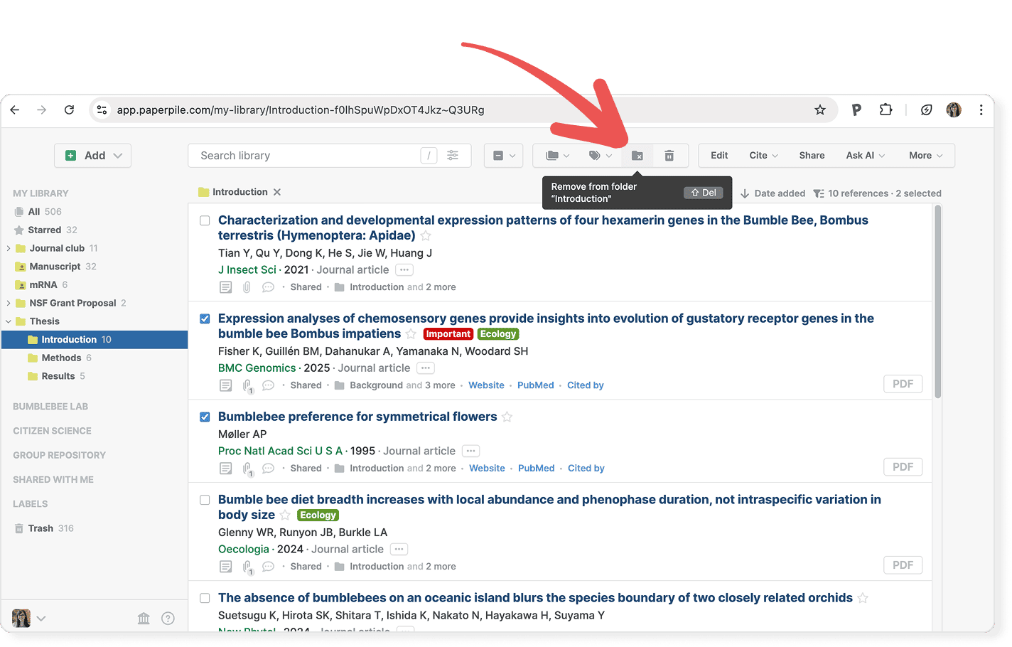 The Introduction folder open with two of ten references ticked, and a red arrow pointing to the toolbar’s folder button, which shows a “Remove from folder ‘Introduction’” tooltip with its shortcut.